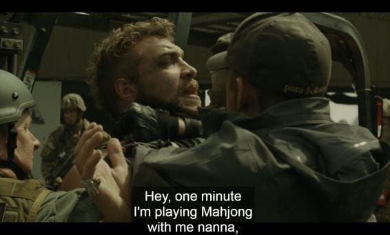 Film still of a subtitled scene in which a character says he is playing mahjong with his nan