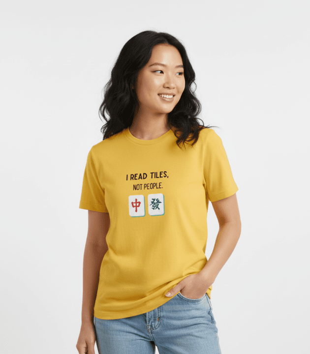 Woman wearing a yellow mahjong T-shirt reading “I read tiles, not people”